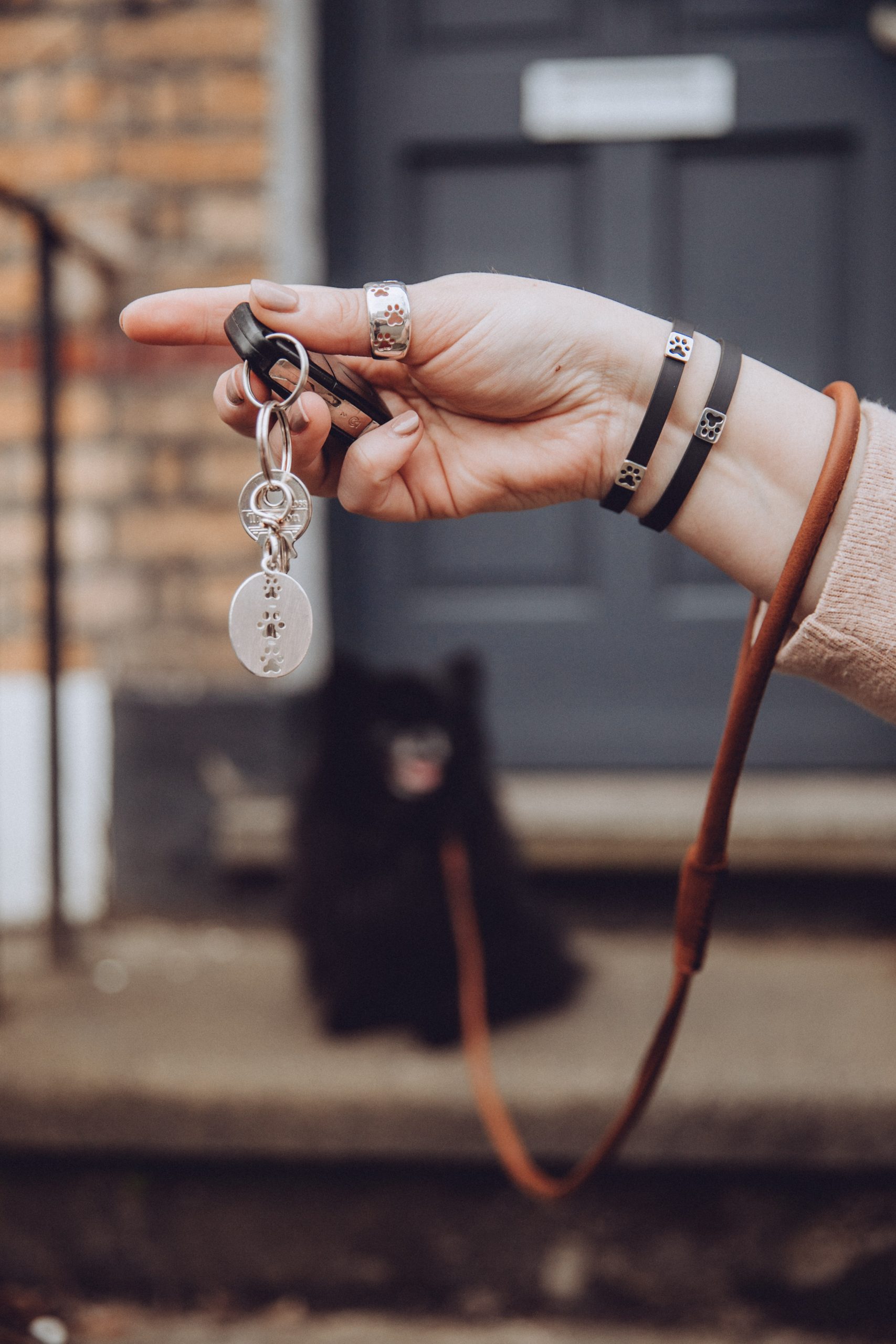 Silver key ring attached to car keys, while Kimberly wears the silver paw print ring, and rubber paw print bracelets