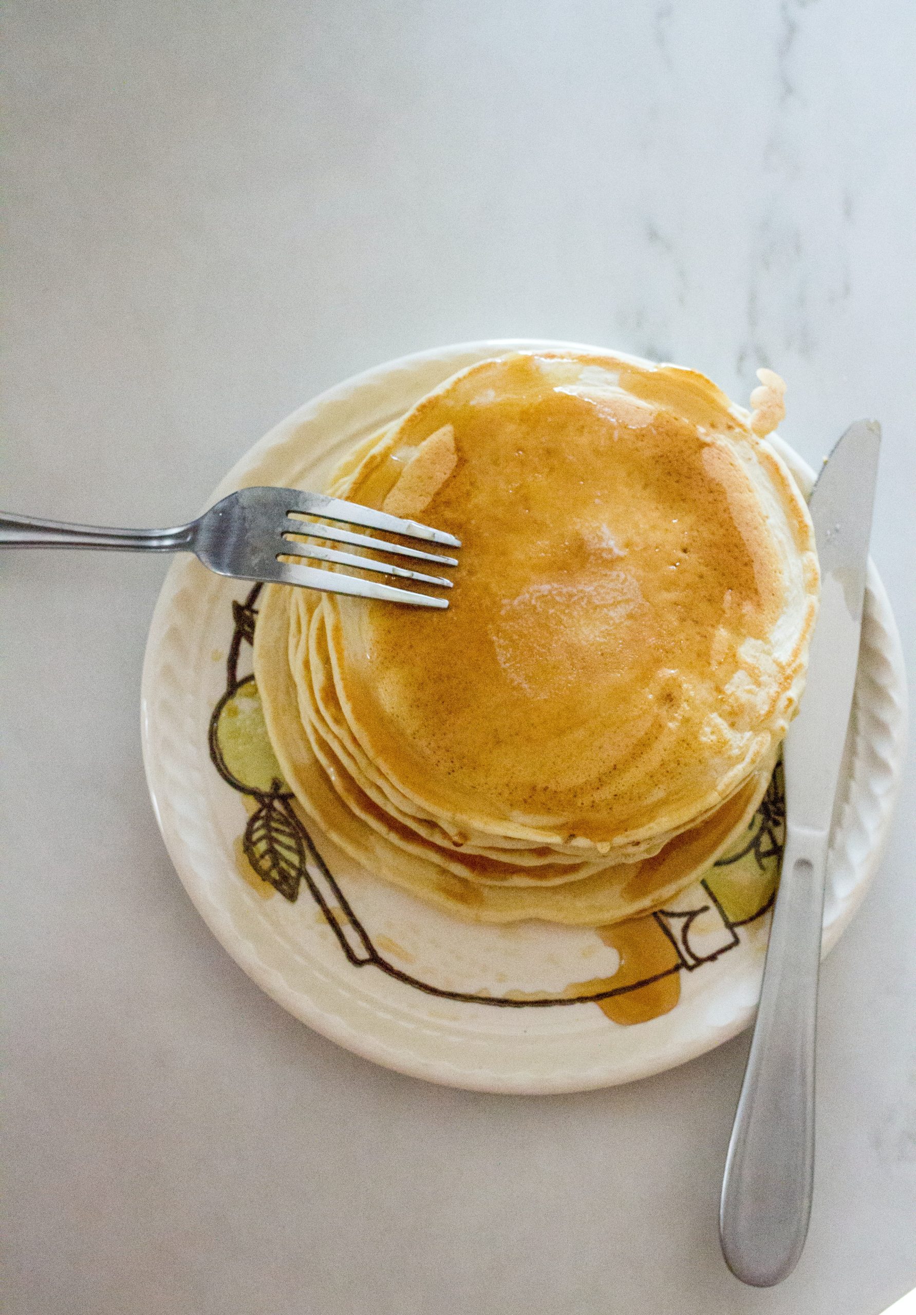 pancakes with fork and knife in saucer